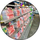Shelf rows filled with Nintendo Switch game cases arranged in a video game store, with bright red spines lined up in neat rows.