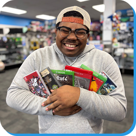 Person smiling while carrying multiple video game cases