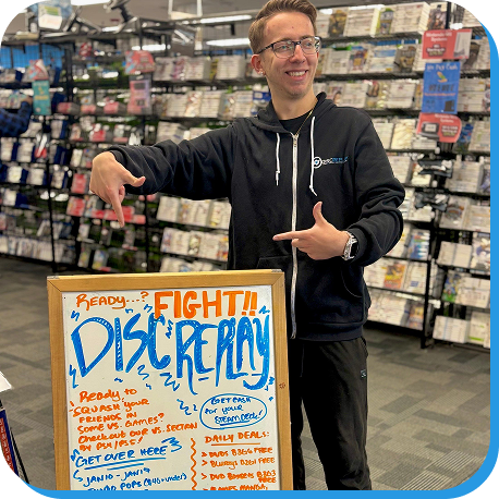 Disc Replay employee standing beside promotional whiteboard