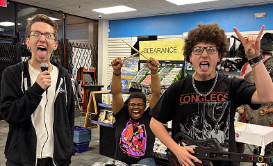 Group of friends playing Rock Band instruments in a video game store