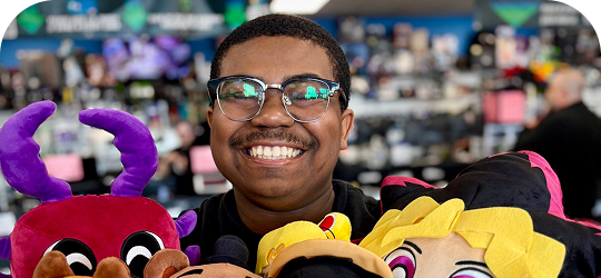 Disc Replay employee smiling with plush toys