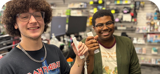 Two Disc Replay employees smiling and holding Wii controllers