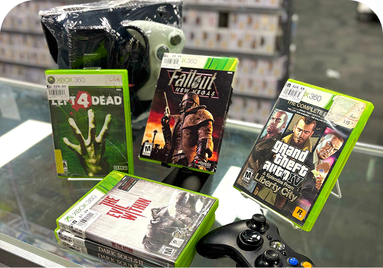Xbox 360 games and controller displayed on a store counter